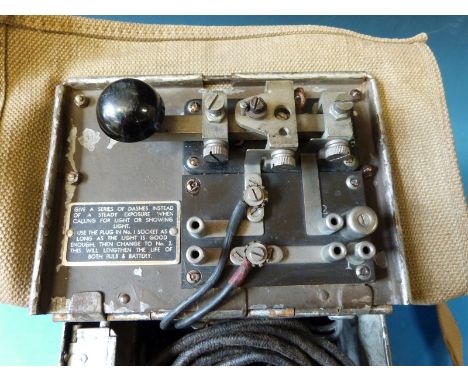 A WWII signalling lamp, daylight short range, complete with coloured lenses, inspection lamp, spare bulb, instructions, spike