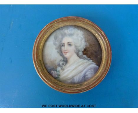 An 18thC round portrait miniature on ivory of a lady wearing a white dress, in gilt frame, diameter 4.1cm