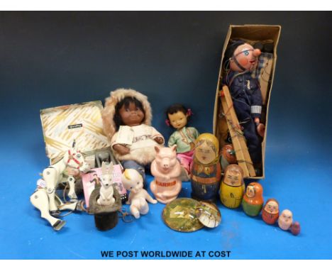 A Pelham puppet the Policeman and one other together with cast metal donkey puppet and two dolls etc