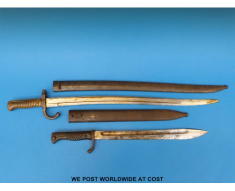 A French bayonet in scabbard dated to blade back 1870, together with a German bayonet by Waffenfabrik Mauser