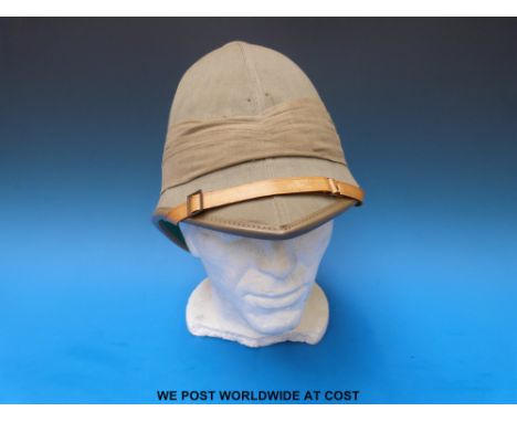 A military pith helmet with leather chin strap and sweat band