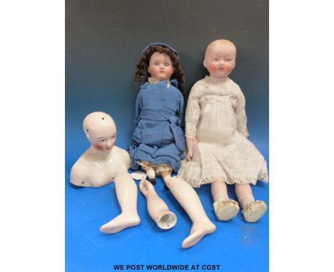 Two bisque headed dolls one with painted features, the other with glass eyes, both in period dress together with a ceramic do