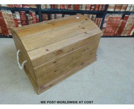 A small pine trunk with domed top and rope handles width 55cm
