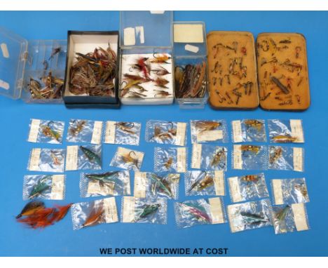 A collection of vintage gut eyed salmon fishing flies, some individual named Hardy flies in original packets, some loose larg