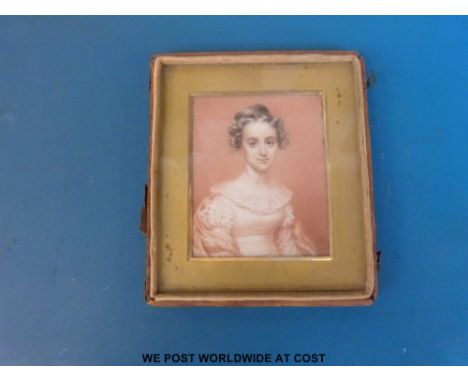 An early 19thC rectangular portrait miniature of a lady wearing a pink dress with lacy neckline, label verso 'Unknown 1815' (