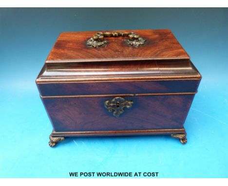 A 19thC mahogany tea caddy raised on brass claw feet