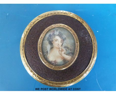 A Georgian tortoiseshell snuff box, the lid having an oval portrait miniature of a lady in a blue dress and hat, the round bo