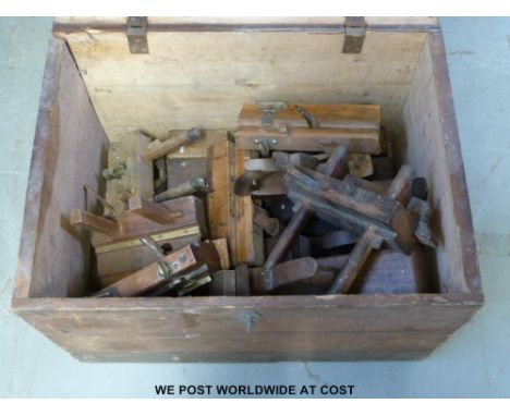 A wooden tool chest containing a variety of woodworking planes by John Moshley and Son, W Greenslade Bristol, D Hinnels, Grif