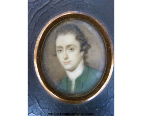 A Georgian oval portrait miniature of a gentleman wearing a green coat mounted in black rectangular frame, label verso 'name 