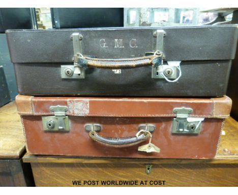 Two vintage suitcases, one marked Revelation