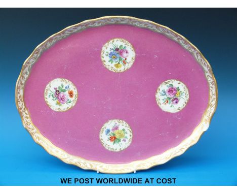 An oval ceramic tray with floral cartouches and Vienna beehive mark to base (42cm long) 
