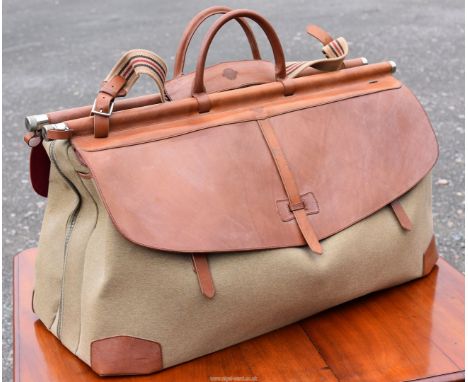 A Purdey 'Side by Side Weekend Bag', model no. 00073, with gunslips, 33 1/4'' wide x 18'' high approx., (never been used).