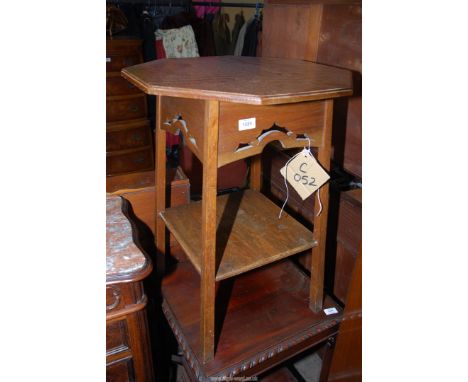 An octagonal Oak occasional Table having fretwork details the legs united by a lower shelf, 20'' x 20'' x 27'' high approx.