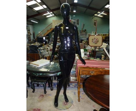 A black gloss full body shop mannequin, 73" tall. N.B. VAT at 20% will be added to the hammer price of this lot.
