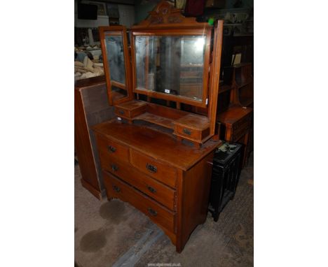 A Satinwood dressing Chest having two long and two short Drawers, the triple bevelled mirrors supported on a shelf with two t