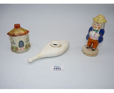 A 19th c. Staffordshire money box in the form of a house, figure of a gentleman with pepper pot hat and a small porcelain med