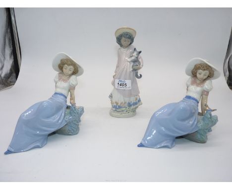 A Lladro girl with a kitten and two Nao figures of a girl with a bird.