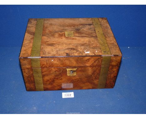 A Walnut correspondence box with brass banding and escutcheon, having a black leather insert with gold tooled detail, with gl