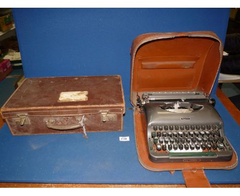 A portable Imperial 'Good Companions' Typewriter and leather suitcase, 18" wide x 11" deep x 5" high.