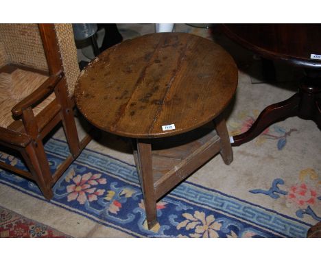 A surprisingly heavy three plank topped period Oak and Elm Cricket Table, the canted legs united by a triangular shelf, 23 1/