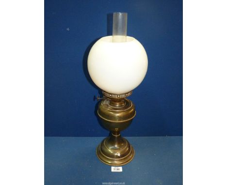 A Brass oil lamp with chimney and white glass shade (some chips), 20 1/4" tall.