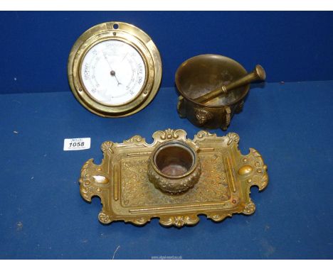 Three brass items to include; a heavy 19th Century gilt pestle and mortar having lion mask panels (4" diameter), a highly dec