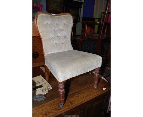 A Rosewood and other woods low/nursing Chair having turned and fluted front legs and button-back upholstered in beige dralon 