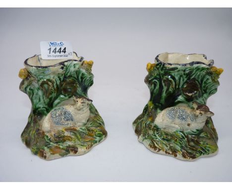 A pair of Staffordshire Spill vases of lambs resting by a tree trunk with a bird either side, circa 1870, some age wear, 3 3/
