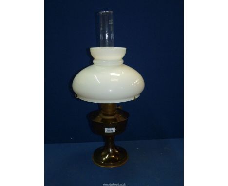 A brass Oil lamp with white glass shade. 22" tall
