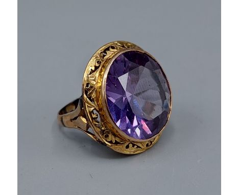 A 14ct gold ring set with a large circular Amethyst, 8.8gms, ring size J