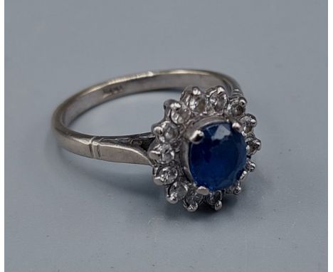 An 18ct white gold Sapphire and Diamond cluster ring, 4.9gms, ring size N