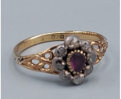 An 18ct gold ring set with a central Ruby surrounded by Diamonds, 2.3gms, ring size O