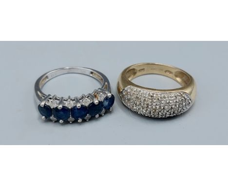 A 9ct gold band ring set with five Sapphire and eight Diamonds together with a 9ct gold Diamond cluster ring, 5.8gms