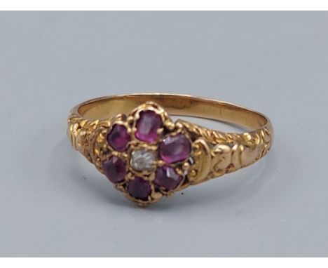 A Ruby and Diamond cluster ring set with a central Diamond surrounded by Rubies, 2.5gms, ring size P