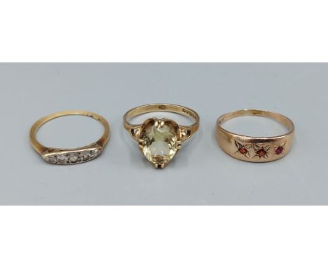 An 18ct gold ring set with five diamonds, 1.2gms together with a 9ct gold dress ring and another gold ring, 3.7gms