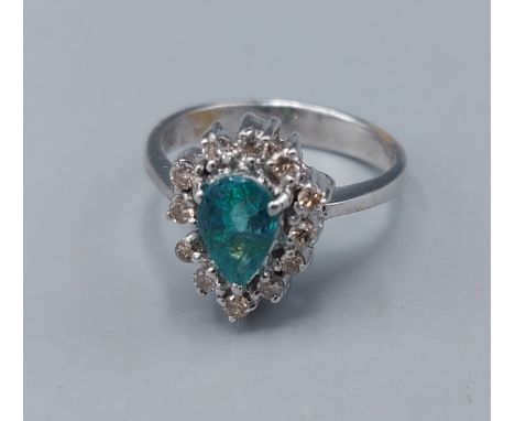 An 18ct white gold Emerald and Diamond cluster ring, 5.9gms, ring size N