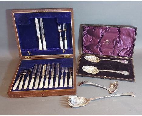 A set of dessert knives and forks with M.O.P. handles in case together with a pair of plated berry spoons and a plated ladle 