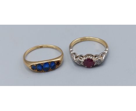 An 18ct gold ring set with an Amethyst flanked by Diamonds, 2.6gms, ring size K together with an 18ct gold ring set Sapphires