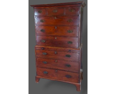 A 19th Century mahogany chest on chest, the moulded cornice above three short and six long graduated drawers with oval brass 