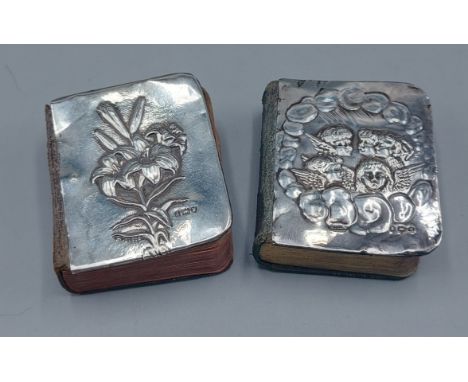 A Birmingham silver prayer book cover decorated Whispers together with another similar 