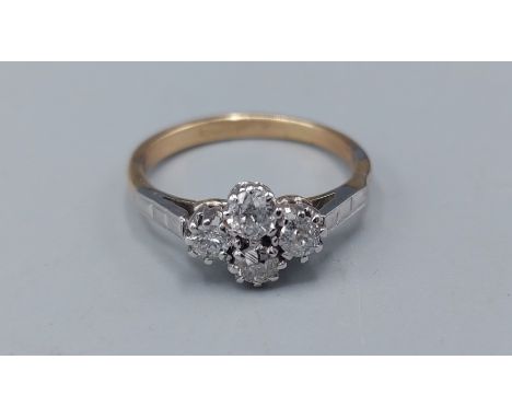 An 18ct gold ring set with four Diamonds within a pierced setting 