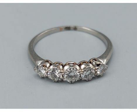 A white gold five stone Diamond ring set with five graduated Diamonds within a pierced setting, 2.3gms, ring size M