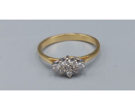 An 18ct gold Diamond cluster ring, set with nine Diamonds within a pierced setting, 2.5gms, ring size M