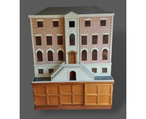A large dolls house in the form of a Georgian mansion with lighting, furniture and accessories, 120cms wide, 60cms deep and 1