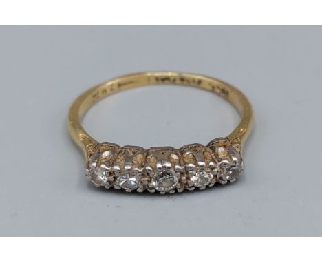 An 18ct gold ring set with five Diamonds within a pierced setting, 2.7gms, ring size O