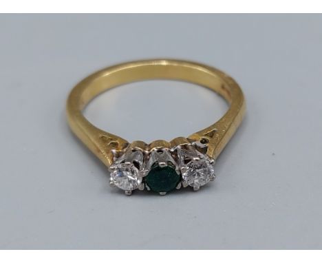 An 18ct gold Emerald and Diamond three stone ring, 3.4gms, ring size L