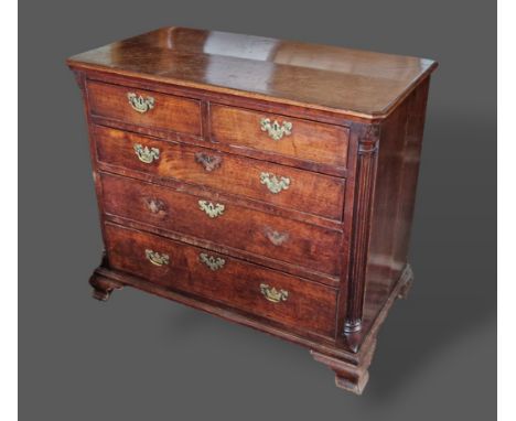 A George III oak chest of two short and three long drawers flanked by quarter pilasters and raised upon Ogee bracket feet, 93