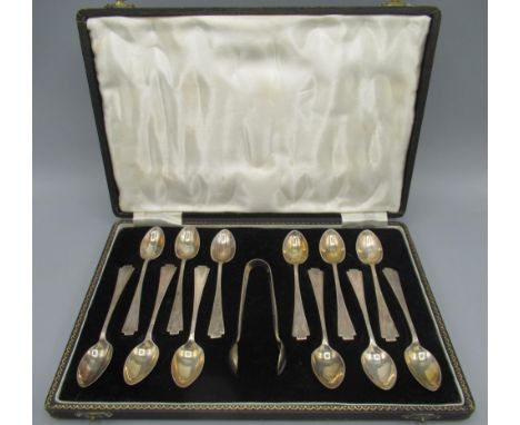 C20th silver cased set of twelve teaspoons with sugar tongs, in an Art Deco style, triangular engine turned finials by Joseph