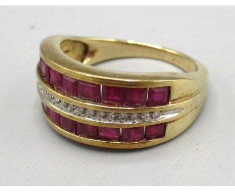 9ct yellow gold diamond and ruby ring, the central row of diamonds surrounded by square cut rubies, stamped 375, 4.05g
