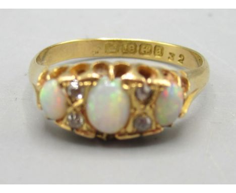18ct yellow gold opal and diamond ring, the three cabochon opals separated by brilliant cut diamonds, stamped 18, size O, 2.9